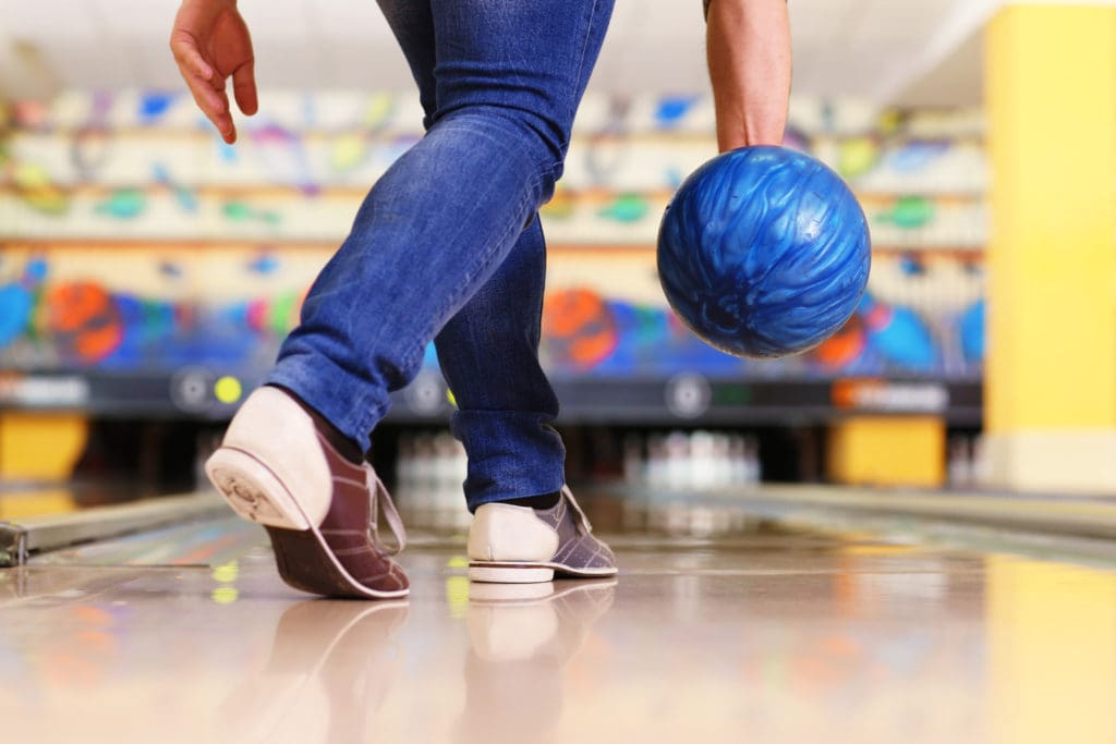 Male legs and bowling ball